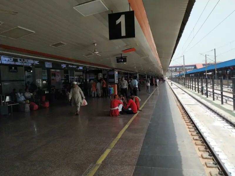 A platform at New Delhi railway station with a train waiting.