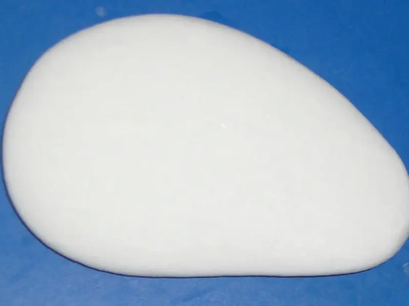 A plain bar of soap resting on a surface.