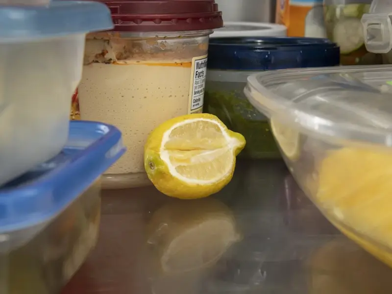 An open refrigerator with food arranged across its shelves.