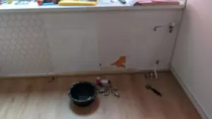 A central heating radiator fitted beneath a window in a domestic room.