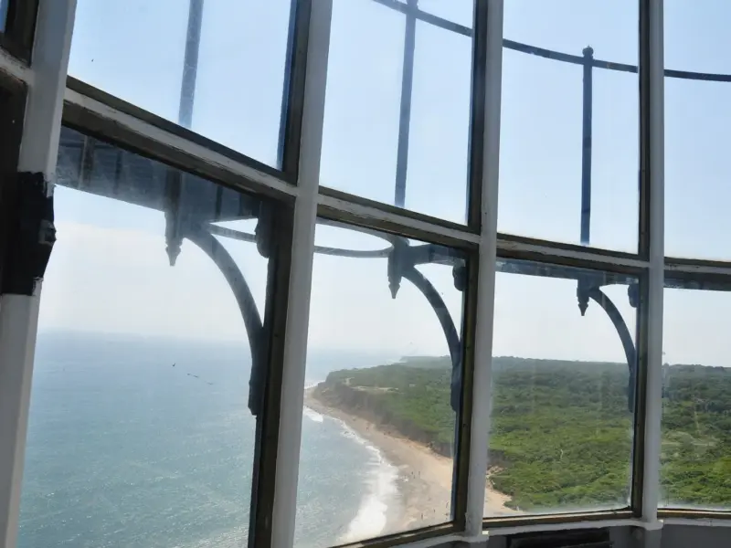 Inside the lantern room at the top of a lighthouse, looking out through the glazing.