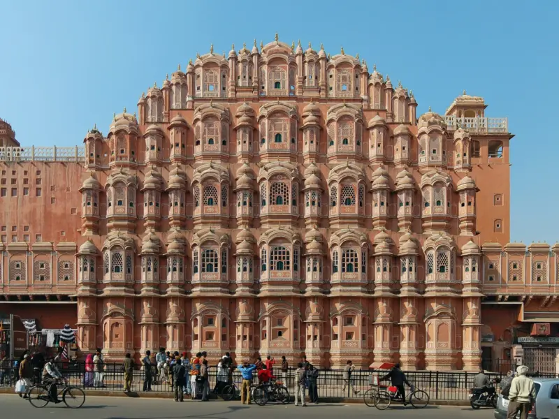 The pink sandstone facade of Hawa Mahal in Jaipur, with its many latticed windows.